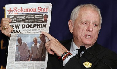 Former dolphin-trainer Ric O'Barry speaks while showing a newspaper reporting about his action during a press conference at the Foreign Correspondents' Club of Japan in Tokyo, Japan, Monday, Sept. 6, 2010. O'Barry, the star of the Oscar-winning documentary "The Cove" about the Japanese dolphin hunt, said that activists trying to stop the killing might need to back off and allow the Japanese people to tackle the issue themselves. (AP Photo/Shizuo Kambayashi)