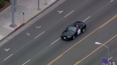 Man With 'Victory Parade' Sign On Car Leading Police On Slow Speed Chase