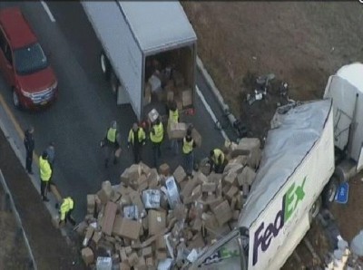 NJ FEDEX Truck Overturns Spills Hundreds Of Holiday Packages On Interstate