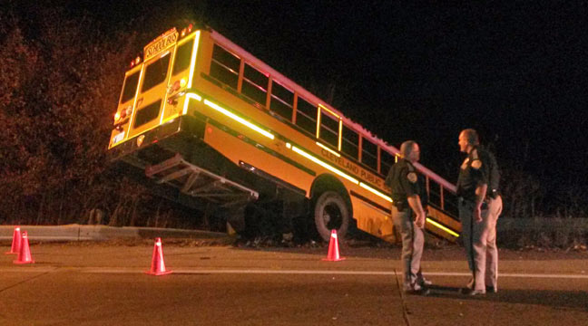 The bus high-centered on a guardrail on Cedar Creek Bridge