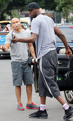 Lamar Odom hits a photographers car with a piece of metal and takes camera gear from another photographers car