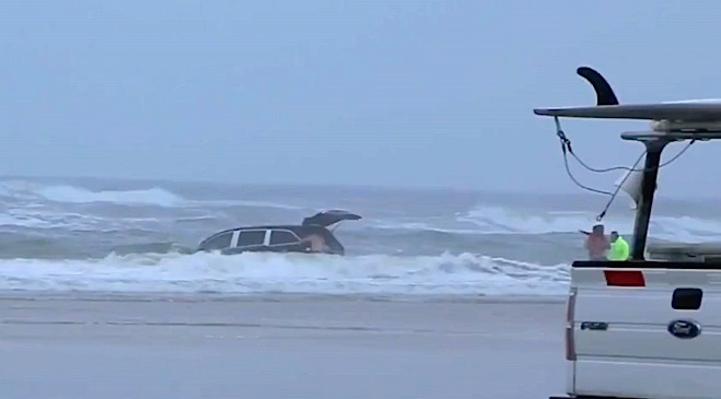 woman drives van in ocean